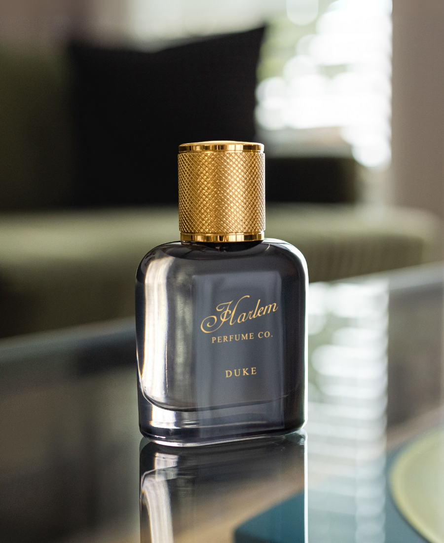 This is an image of our Duke Eau de parfum bottle on a glass table.