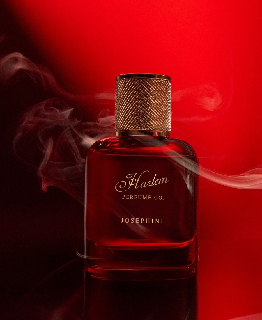 Red perfume bottle labeled 'Flaxen Perfume Co. Josephine' with smoke effect on a red background