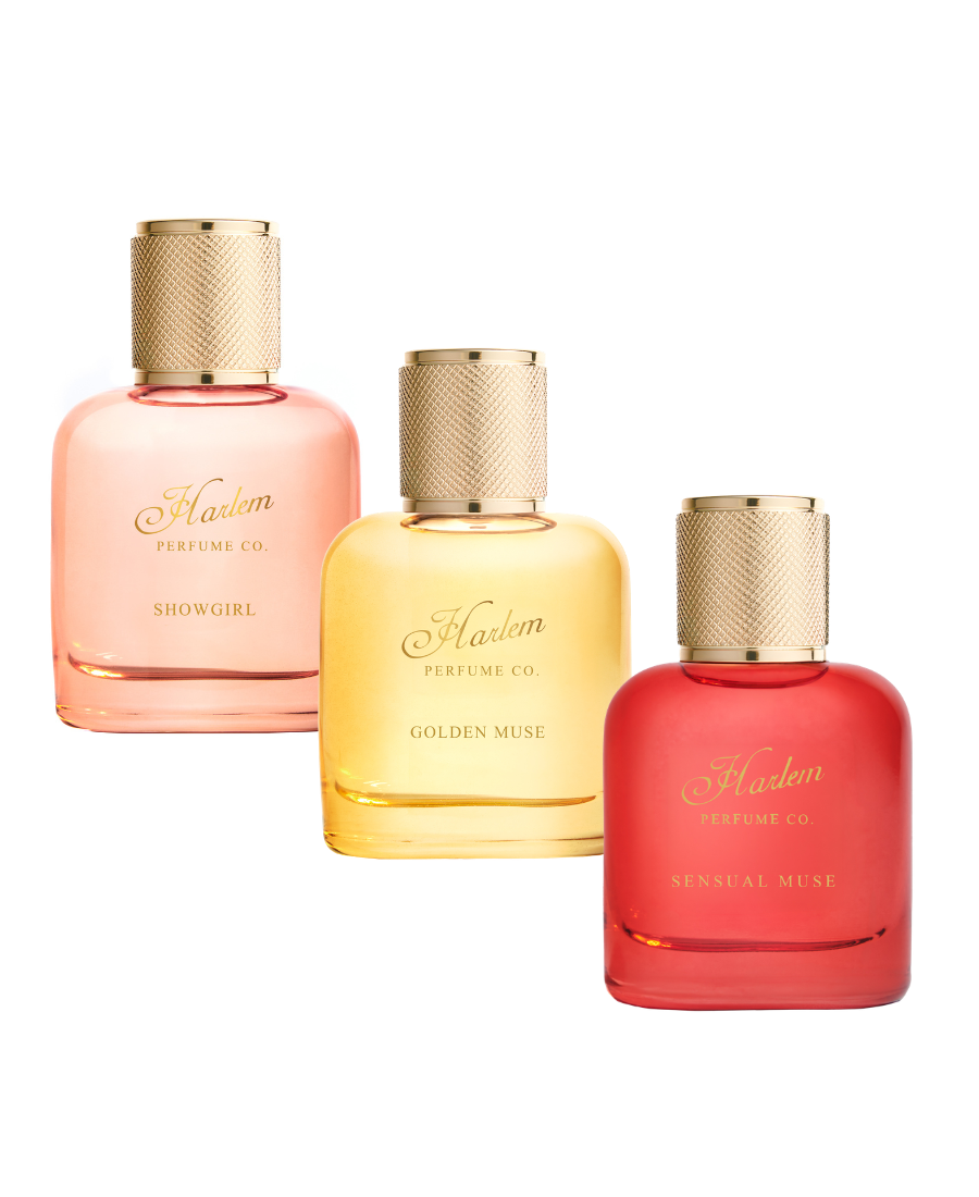 Three perfume bottles from Harlem Perfume Co. arranged in a row against a white background: Showgirl in soft pink, Golden Muse in pale yellow, and Sensual Muse in bright red.