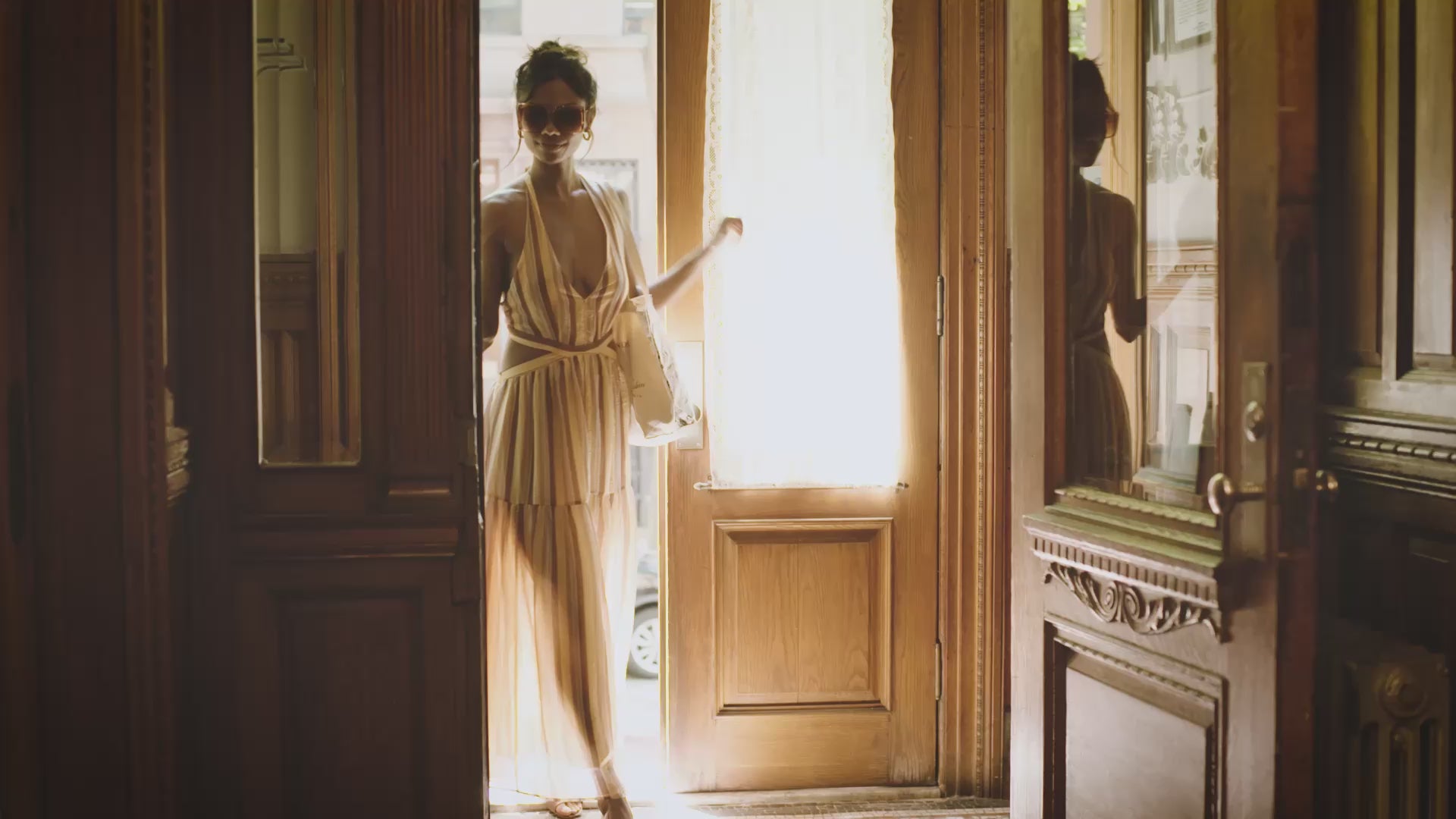 This is a video of a model, walking into a building and being drawn by an artist and spraying the sensual muse perfume on herself