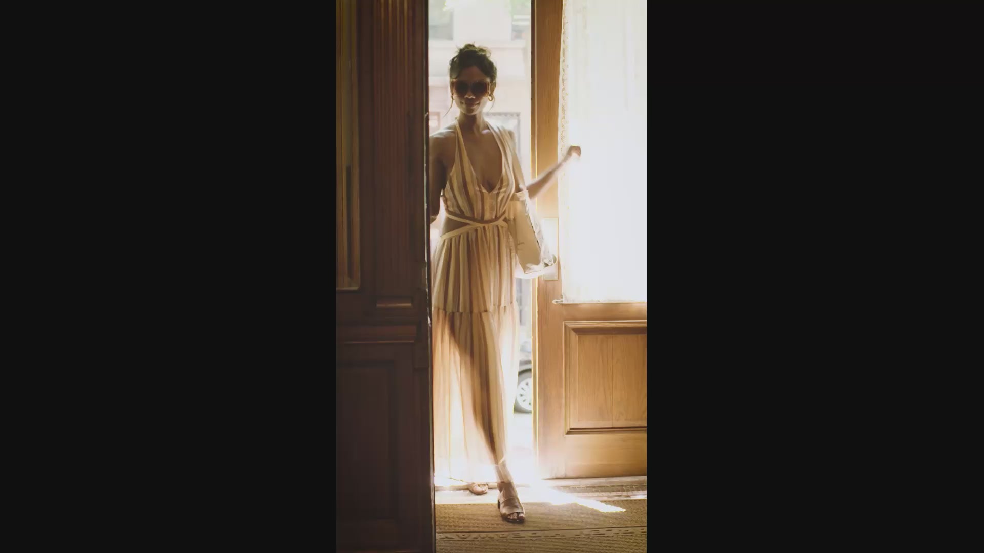 This is a video of a model, walking into a building and being drawn by an artist and spraying the sensual muse perfume on herself
